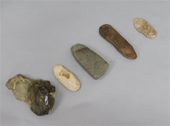 A prehistoric polished grey flint axe head, L 11cm and four other items,